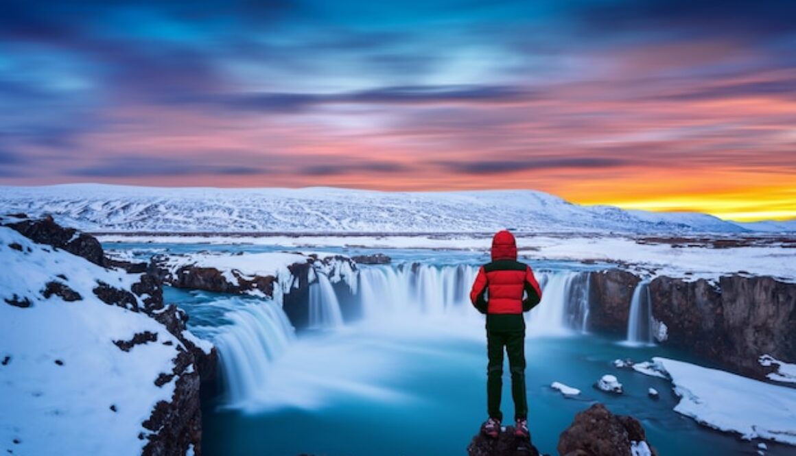 https://img.freepik.com/free-photo/godafoss-waterfall-sunset-winter-iceland-guy-red-jacket-looks-godafoss-waterfall_335224-673.jpg